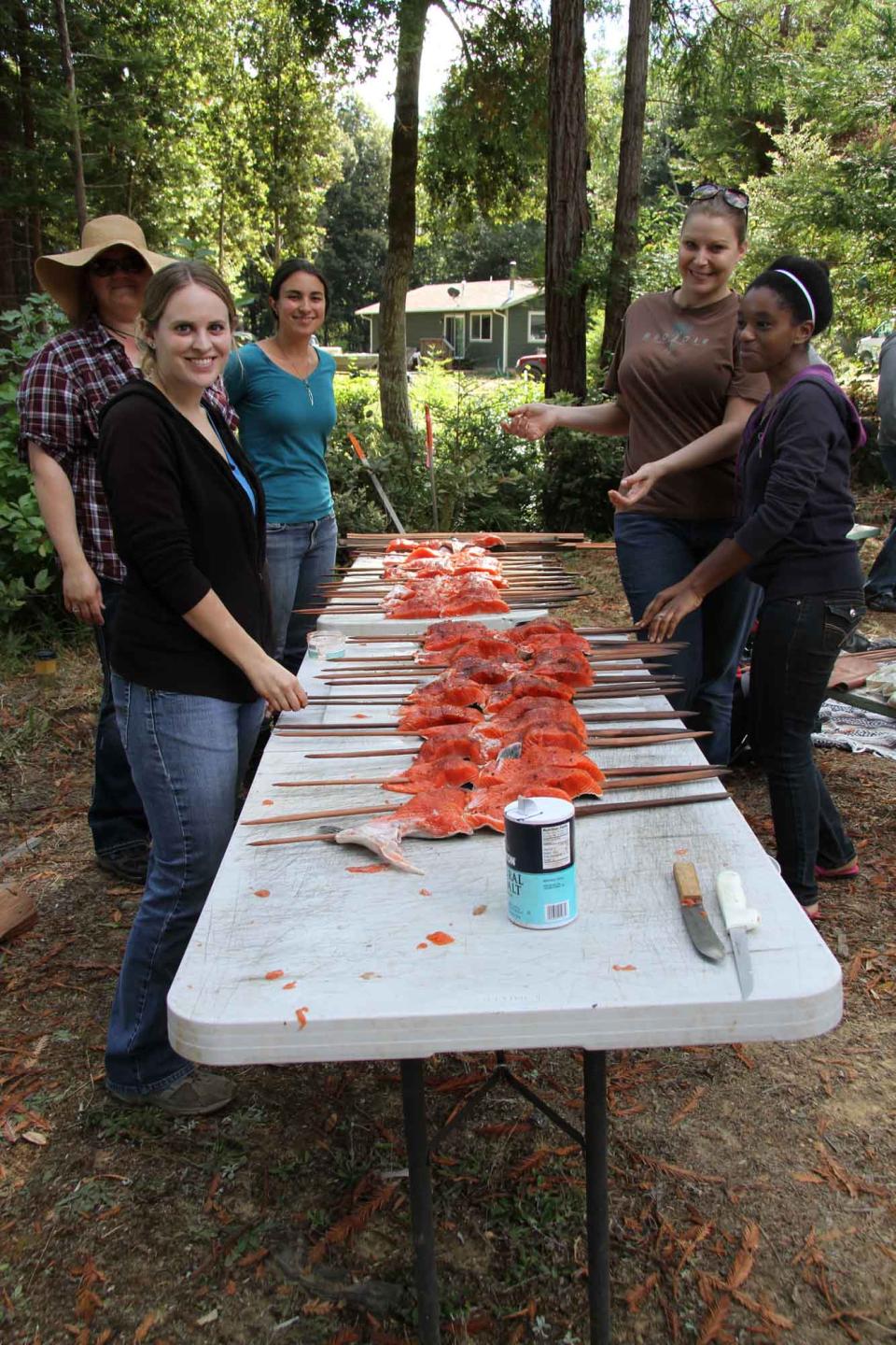 Social Work students learn to make traditional fish sticks at an indigenous site
